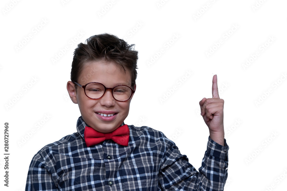 Young schoolchild pointing up portrait. Preteen schoolboy with glasses, gesturing at ceiling. Happy boy, kid in checkered shirt. isolated on white background. Dentistry concept Young schoolchild pointing up portrait. Preteen schoolboy with glasses, gesturing at ceiling. Happy boy, kid in checkered shirt. isolated on white background. Dentistry concept