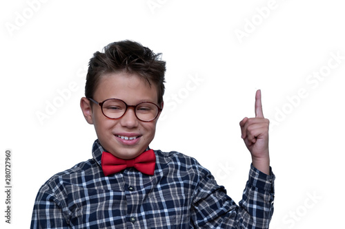 Young schoolchild pointing up portrait. Preteen schoolboy with glasses, gesturing at ceiling. Happy boy, kid in checkered shirt. isolated on white background. Dentistry concept