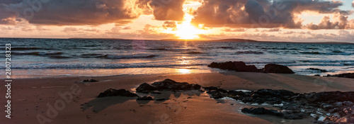 Golden light beach sunset reflection, Atlantic ocean on the west coast of Ireland
