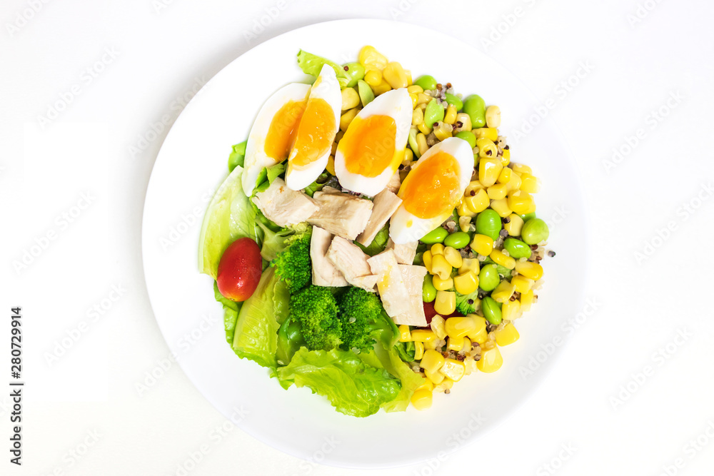 Vegetable salad with chicken breast and boiled egg. Salad with vegetables and grains isolated on white background. Top view