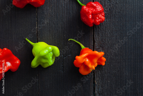 chili peppers on black wood table photo