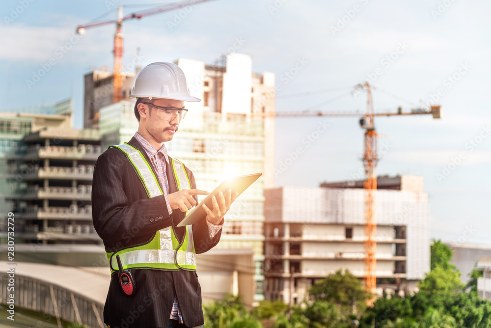 Close up engineers working on a building site holding a blueprints.Engineering and architecture concept Close up engineers working on a building site holding a blueprints.Engineering and architecture concept