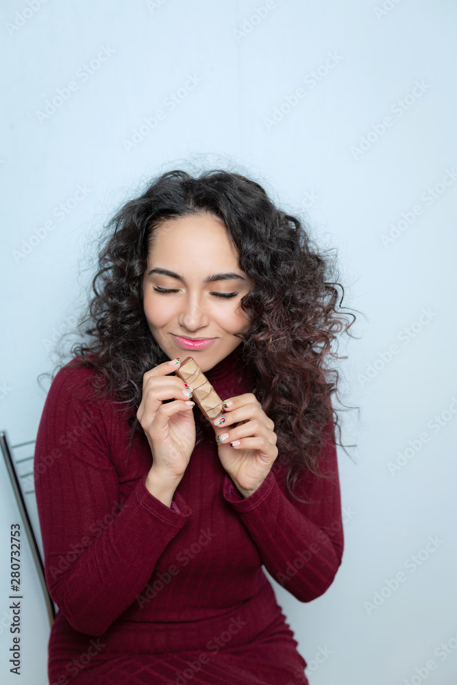 Girl eats a chocolate and shows emotions Girl eats a chocolate and shows emotions