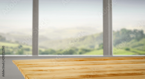 Wooden desk of free space and blurred background of window space  © magdal3na