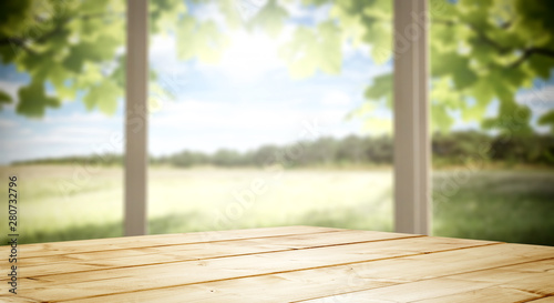 Wooden desk of free space and blurred background of window space 