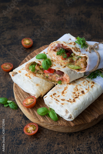 Mexican wrapped burrito with red beans and vegetables