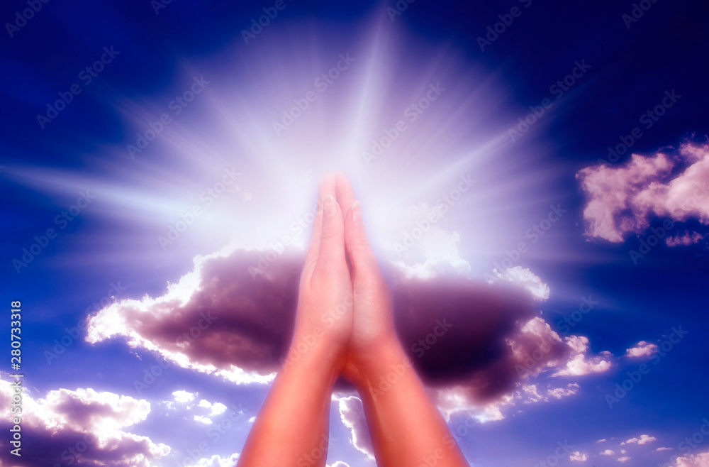 Christian Catholic Prayer praying hands with rays of divine light and
