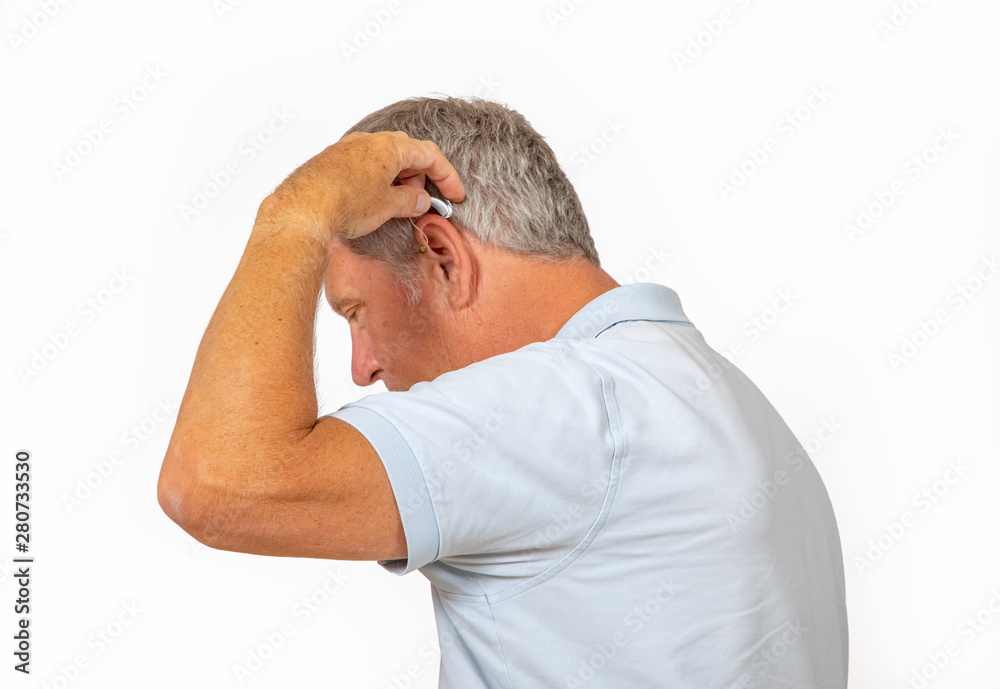 portrait of trustful smiling mature man handling his hearing aid portrait of trustful smiling mature man handling his hearing aid