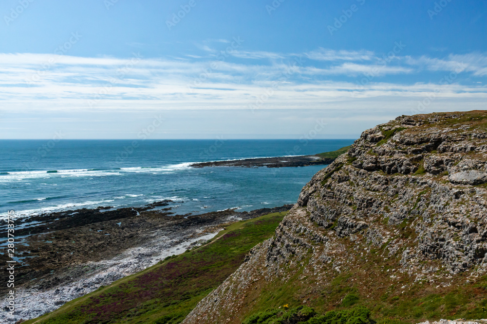 Rugged cliffs dropping into the ocean on the Welsh Coastline (Worm's Head, Rhossili) Rugged cliffs dropping into the ocean on the Welsh Coastline (Worm's Head, Rhossili)