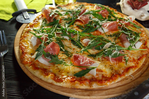 Appetizing pizza with bacon, cheese and herbs