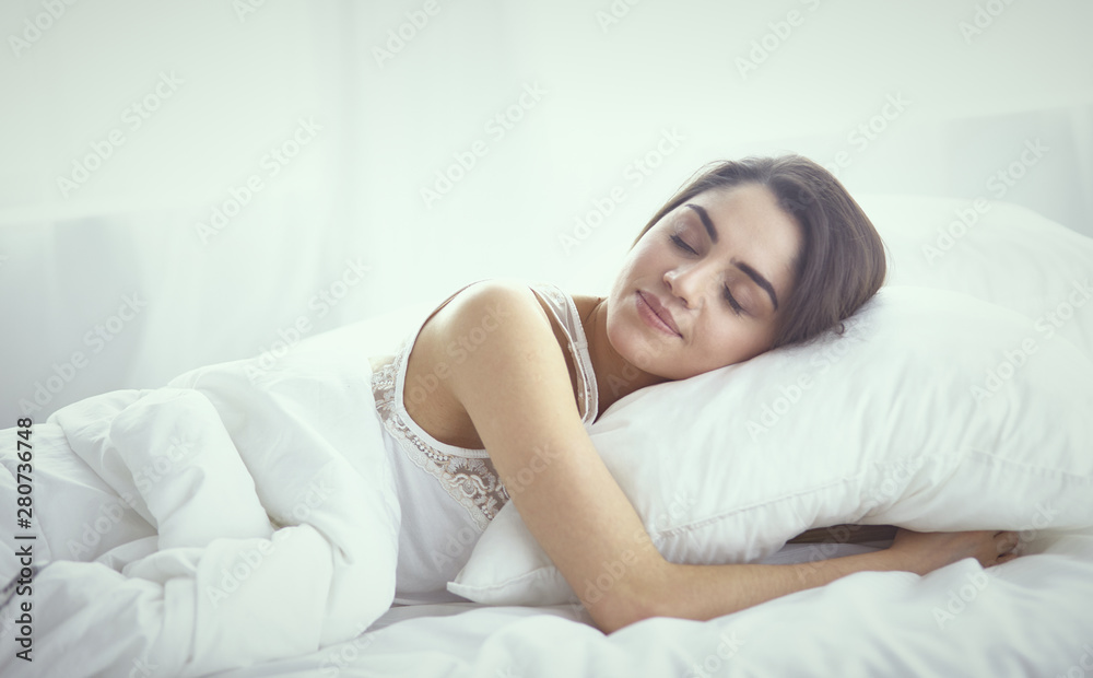 beautiful young woman basking in bed in the morning. Beautiful beautiful young woman basking in bed in the morning. Beautiful