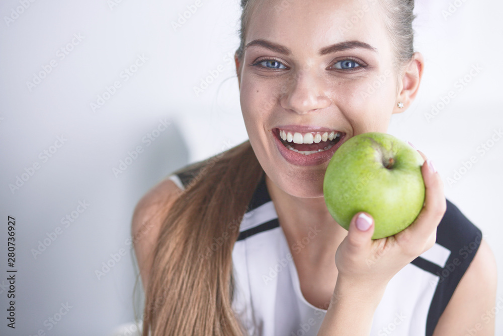 Young beautiful smiling girl with a green apple in hands Young beautiful smiling girl with a green apple in hands