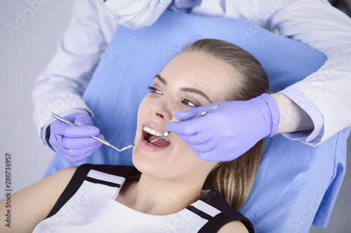 beautiful girl in the dental chair on the examination at the de
