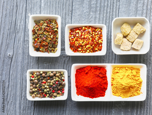 Colorful spices on a dark concrete background