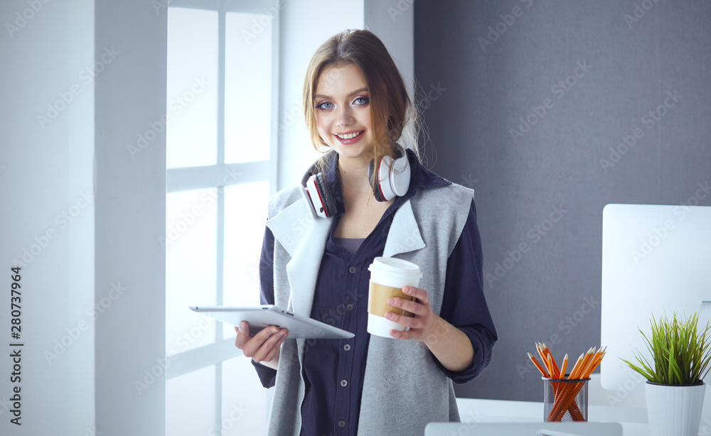 Focused attentive woman in headphones sits at desk with laptop, Focused attentive woman in headphones sits at desk with laptop,