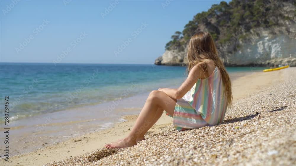 Cute little girl at beach during summer vacation Cute little girl at beach during summer vacation