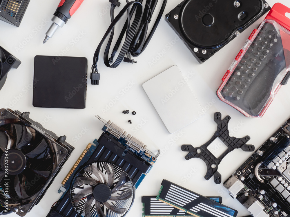 top view of computer parts with harddisk, solid state drive, ram, CPU, graphics card, and motherboard on white table background. top view of computer parts with harddisk, solid state drive, ram, CPU, graphics card, and motherboard on white table background.