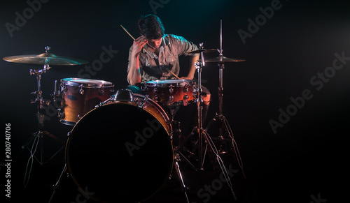 musician playing drums  black background and beautiful soft light