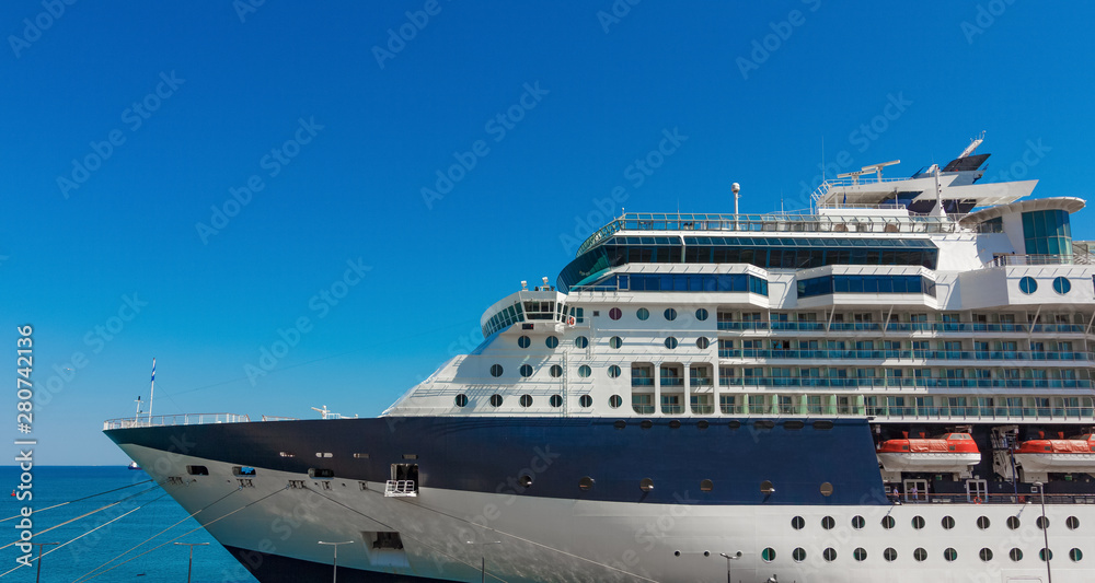 A large luxury cruise liner moored in the port of the Adriatic Sea, is waiting for passengers. There are four orange lifeboats abroad of a cruise ship in Koper, Slovenia.