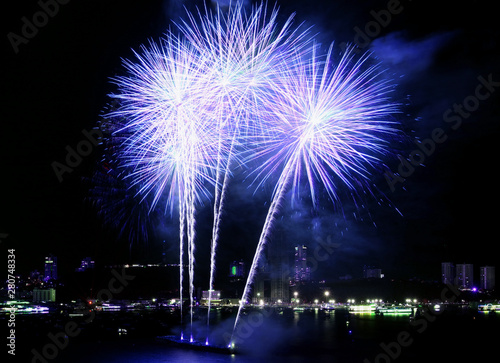 Purple blue fireworks splashing in the night sky over the hatbor photo