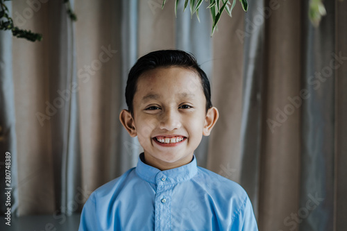 Portrait of south asian handsome little boystanding and smiles. Malaysian people. photo