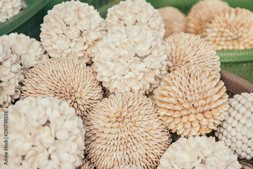 Decorated hand made flowers of shells in Bali shop photo