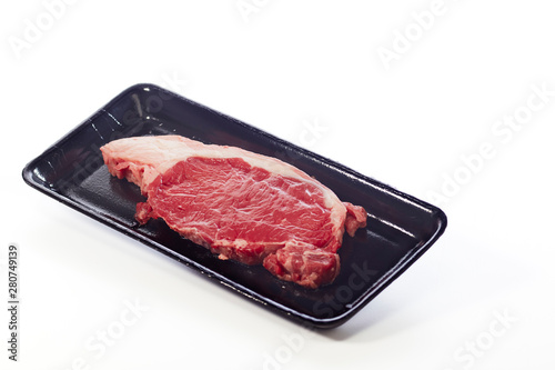 raw beef steak in package on white
