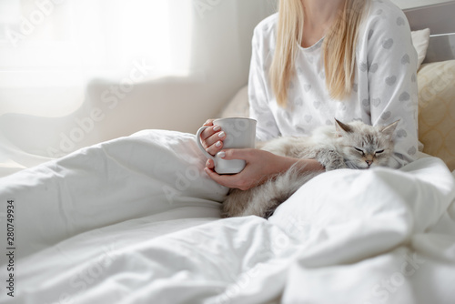 Good morning concept blonde girl with the cat and coffee cup hygge lagom concept. Horizontal copyspace