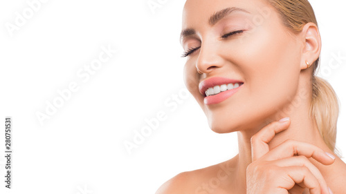 Smiling woman touching skin on the face. Isolated on white