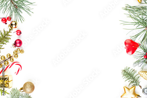 Fototapeta Naklejka Na Ścianę i Meble -  Christmas border made of green Xmas tree twig and New Year decoration on white background