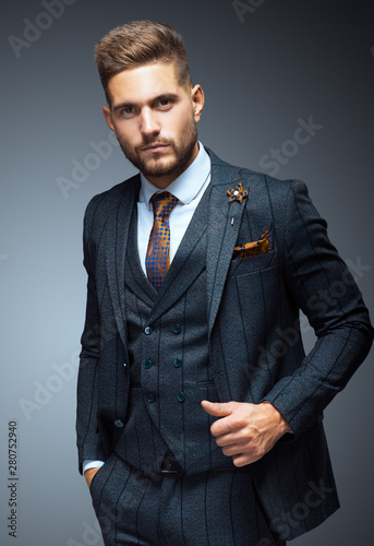 Stylish young man in suit and tie. Business style. Fashionable image. Office worker. Sexy man standing and looking at the camera