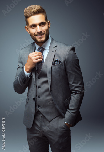 Stylish young man in suit and tie. Business style. Fashionable image. Office worker. Sexy man standing and looking at the camera