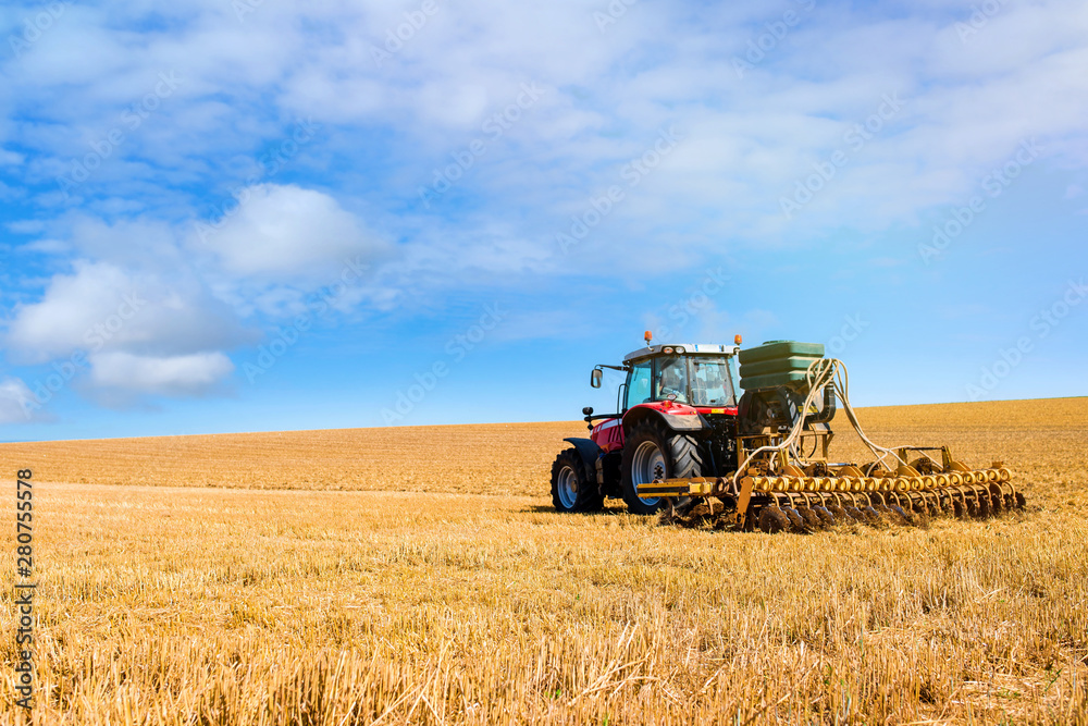 farmer plowing fields after summer grain harvest farmer plowing fields after summer grain harvest