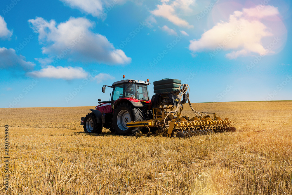Obraz premium farmer plowing fields after summer grain harvest