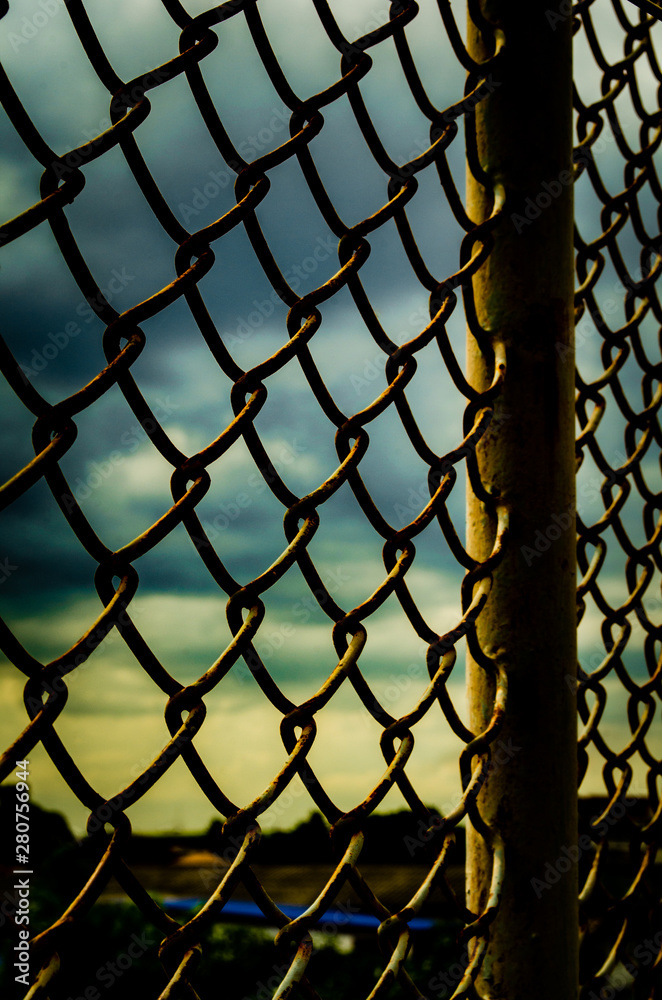 Fototapeta premium The picture of the steel fence that is rusted During the sunset