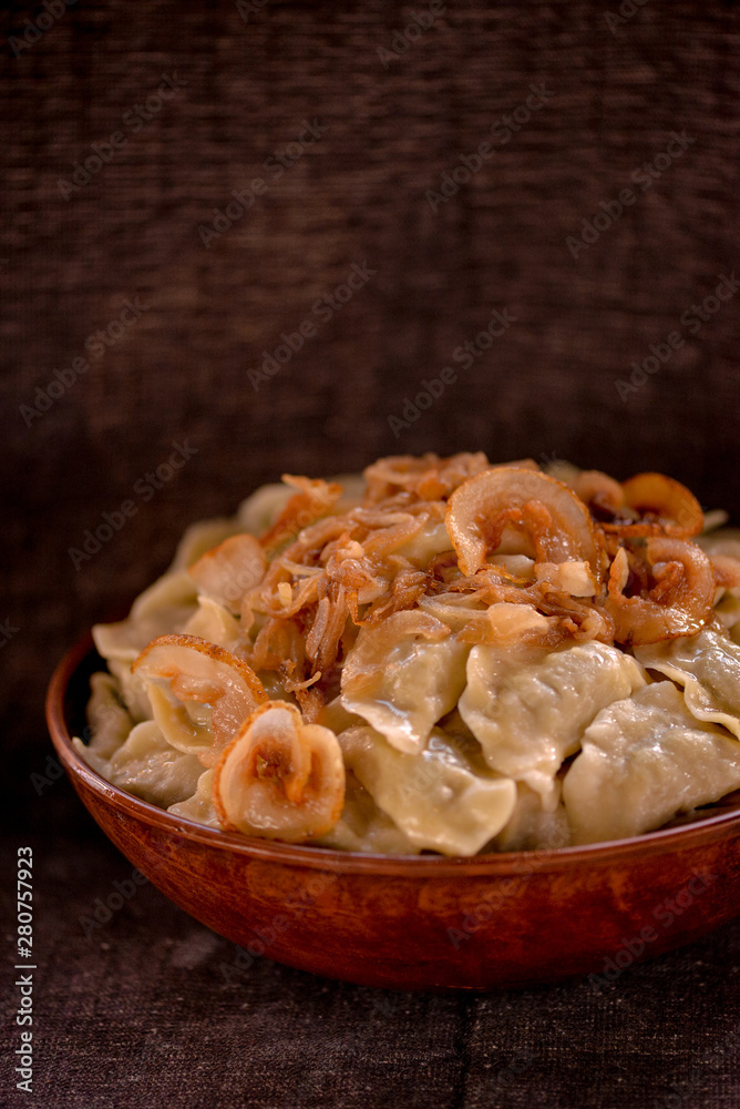 dumplings in a large clay dish on a dark background dumplings in a large clay dish on a dark background