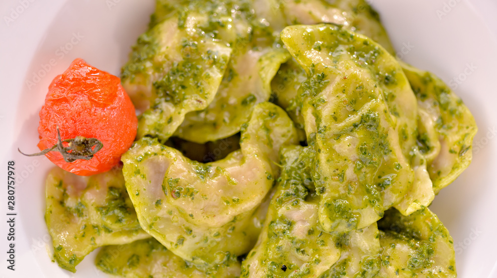 Dumplings are ready in a dish with green sauce Dumplings are ready in a dish with green sauce