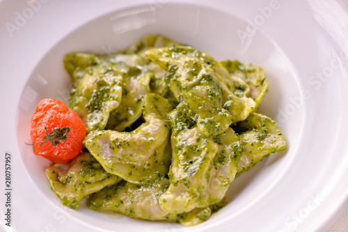 Dumplings are ready in a dish with green sauce