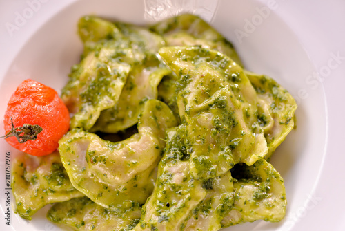 Dumplings are ready in a dish with green sauce