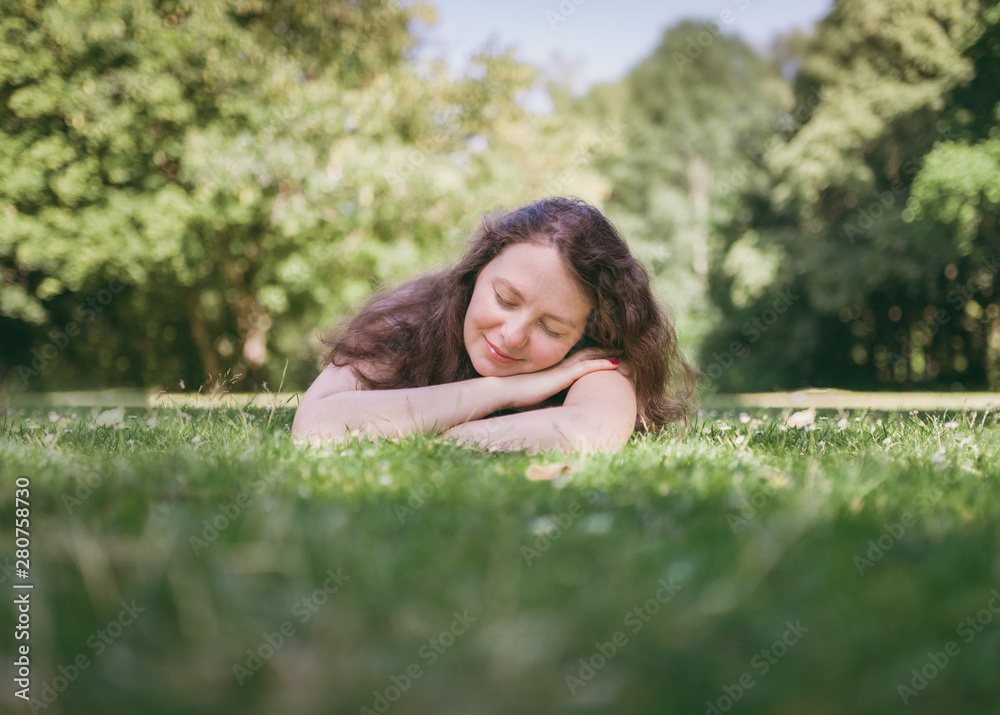 Young, cute woman relaxing in summer park. Outdoor lifestyle. Young, cute woman relaxing in summer park. Outdoor lifestyle.