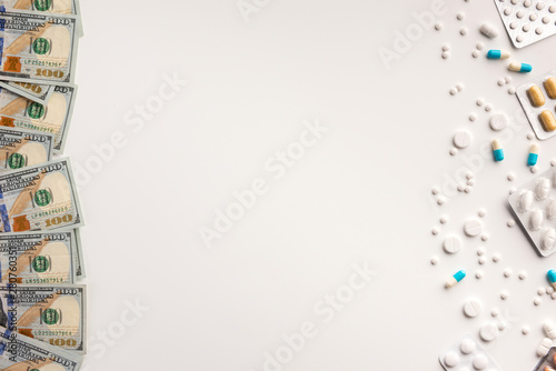 Pills and money isolated on white background