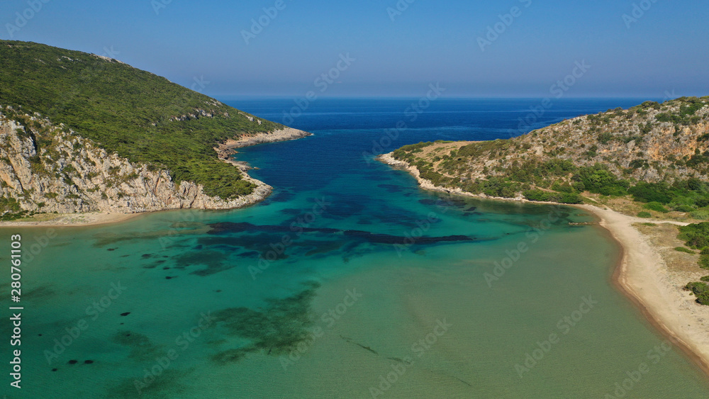 Aerial drone photo of iconic secluded sandy beach with emerald sea in island of Sfaktiria next to bay and famous beach of Divari (chrysi akti), Messinia, Gialova, Peloponnese, Greece