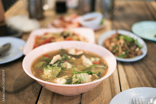 Spicy meal with tom yam kung soup, som tam and larb photo