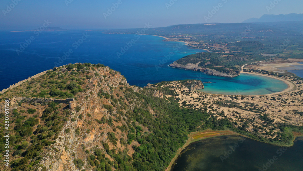 Aerial drone view of semicircular sandy beach and lagoon of Voidokilia, one of the most iconic beaches in Mediterranean sea, with crystal clear turquoise sea, Messinia, Greece