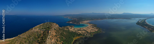 Aerial drone view of semicircular sandy beach and lagoon of Voidokilia, one of the most iconic beaches in Mediterranean sea, with crystal clear turquoise sea, Messinia, Greece