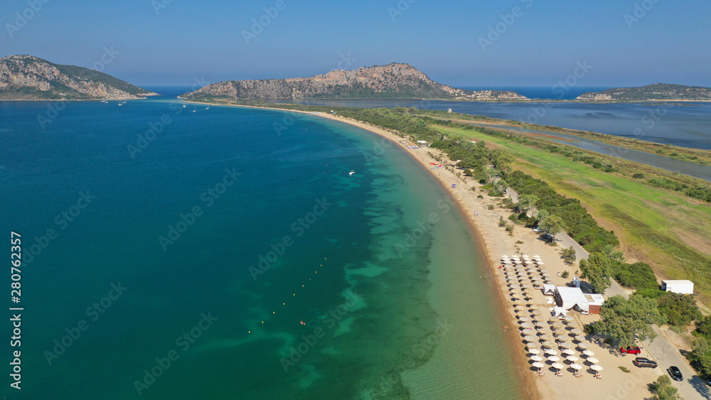 Aerial drone photo of iconic sandy beach of Divari (chrysi akti) with emerald sea near island of Sfaktiria in bay of Navarino, Messinia, Gialova, Peloponnese, Greece
