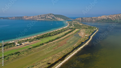 Aerial drone photo of iconic sandy beach of Divari (chrysi akti) with emerald sea near island of Sfaktiria in bay of Navarino, Messinia, Gialova, Peloponnese, Greece