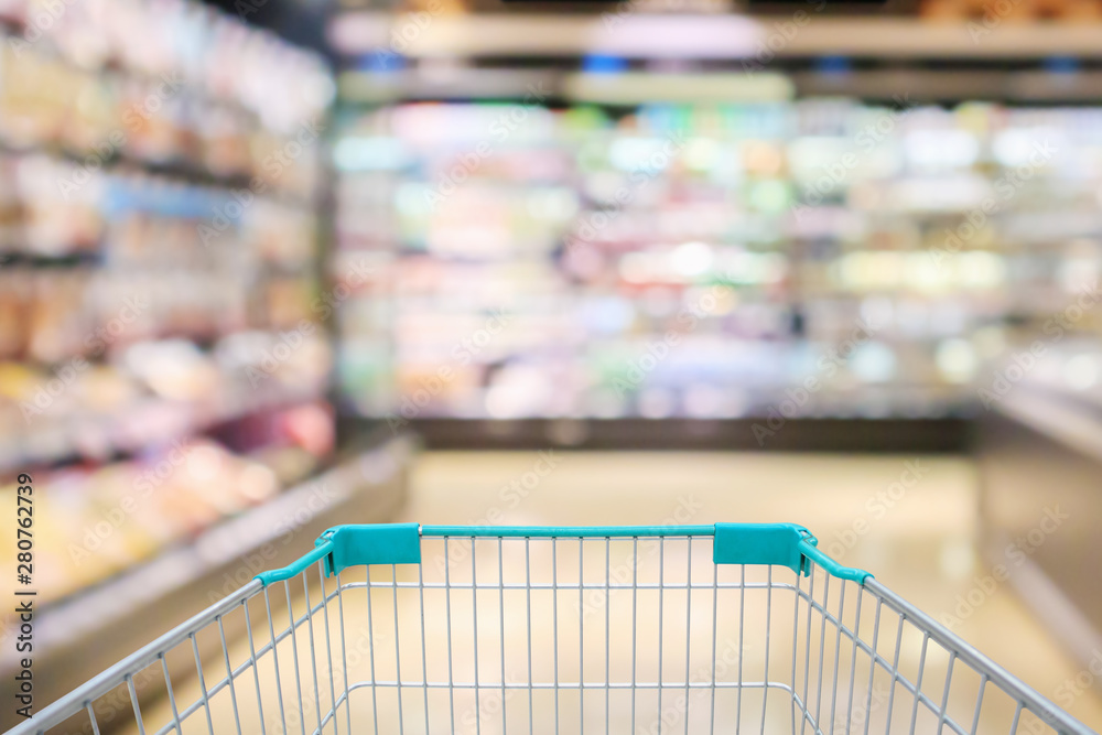 Shopping cart view with supermarket aisle shelves interior abstract blur defocused background