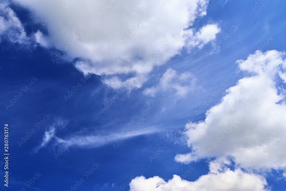 Beautiful white fluffy cloud formations on a deep blue sky