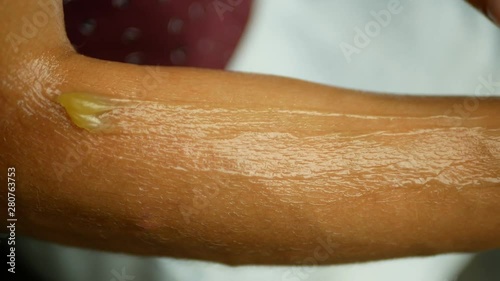 Lubricates cream cannabis or hemp on forearm and hand medicinal cannabidiol CBD, body massage relaxed effect, young woman, marijuana ointment or liniment relax, relieves applying pain scrub